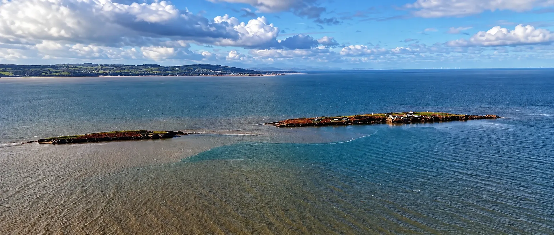 A panoramic aerial view of the Hilbre island chain surrounded by the Dee Estuary