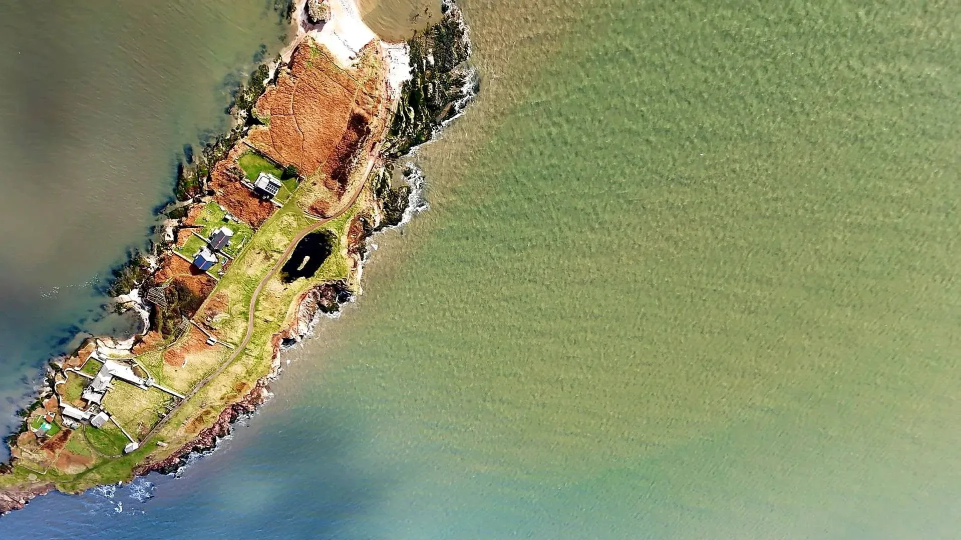 A top-down aerial view of Hilbre Island and its buildings
