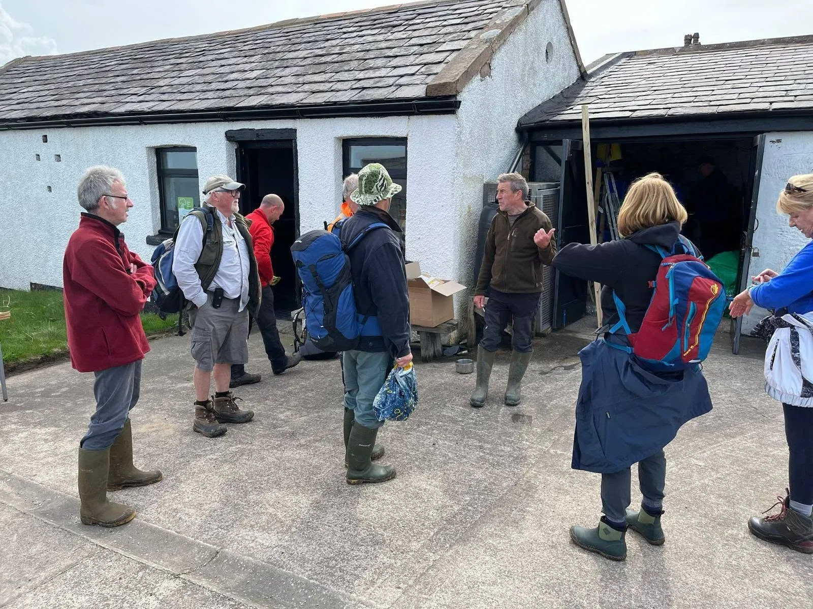 Visitors gathering outside an island building during an organised event