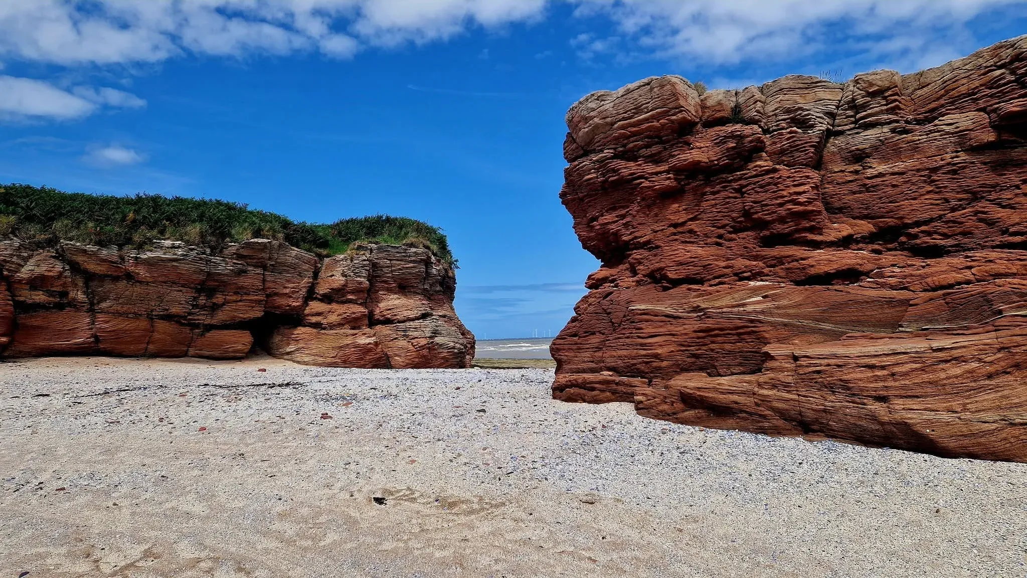 A passage between weathered red sandstone outcrops
