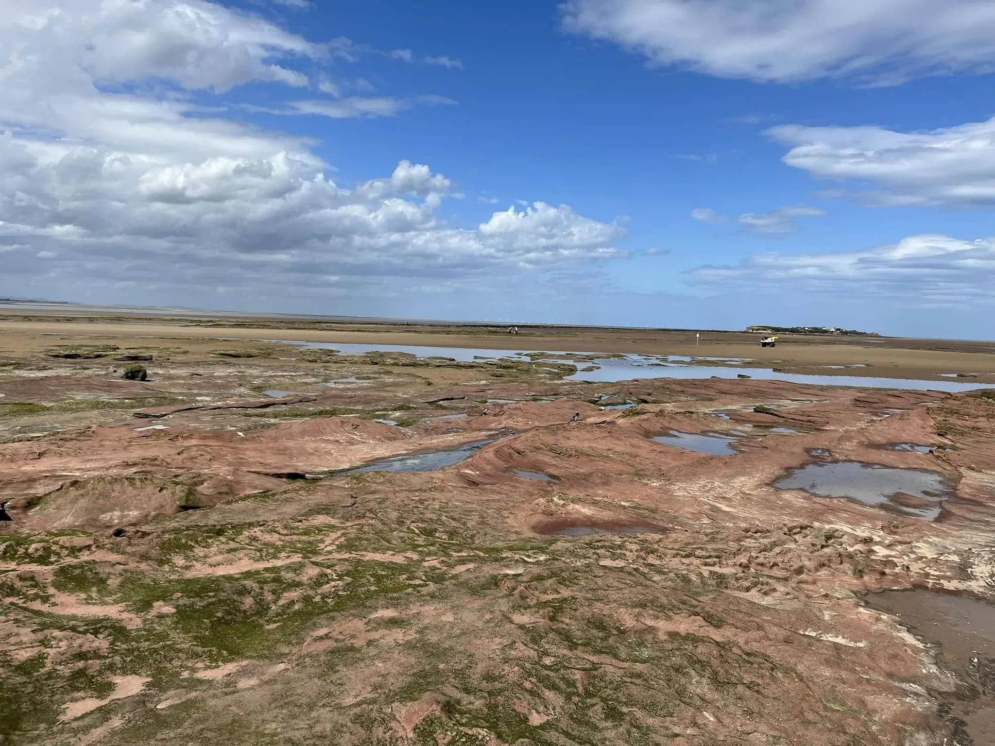 A wide view across the island’s rocky shore and tidal flats